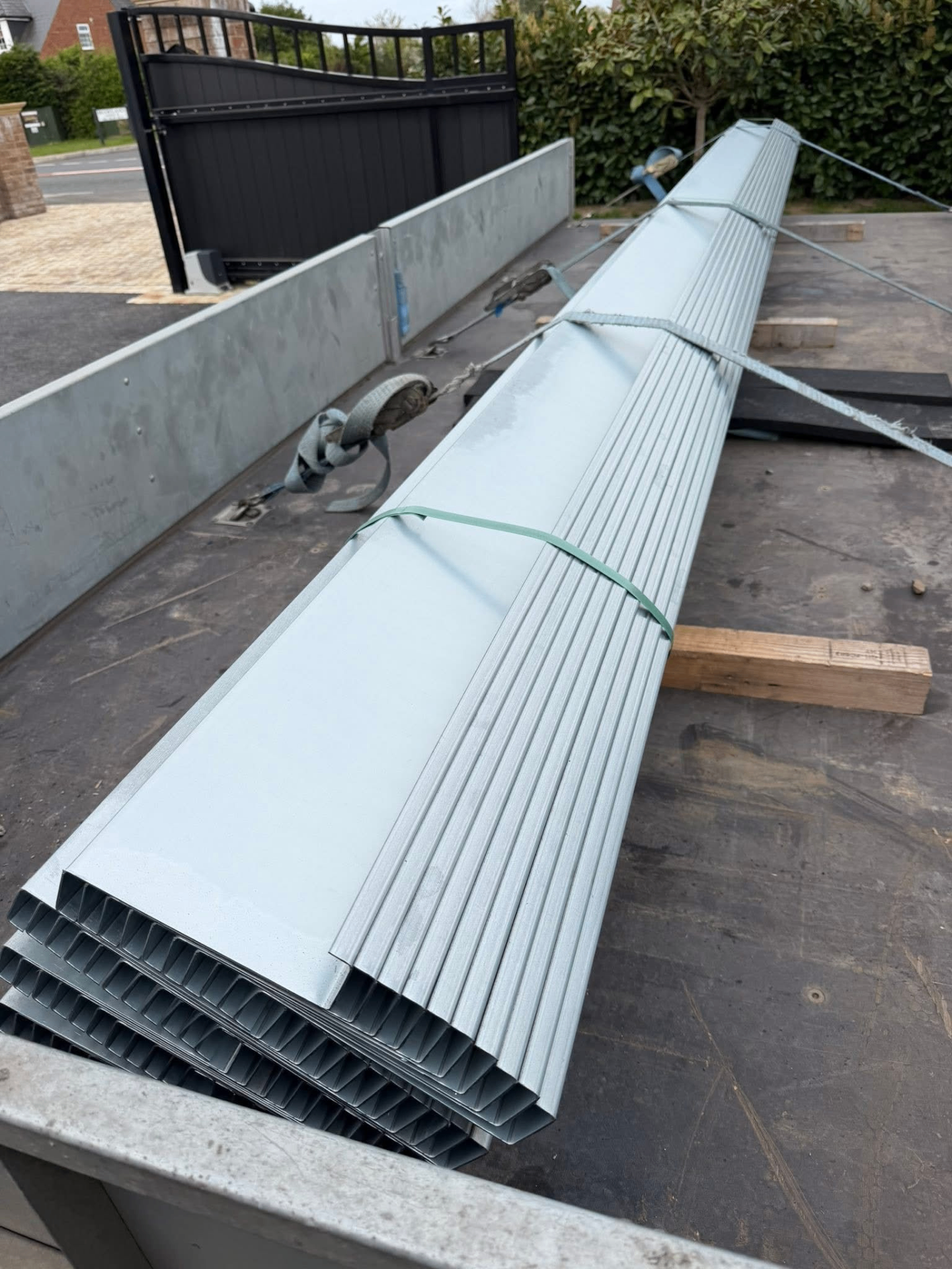Galvanised steel purlins bundled and strapped on a trailer